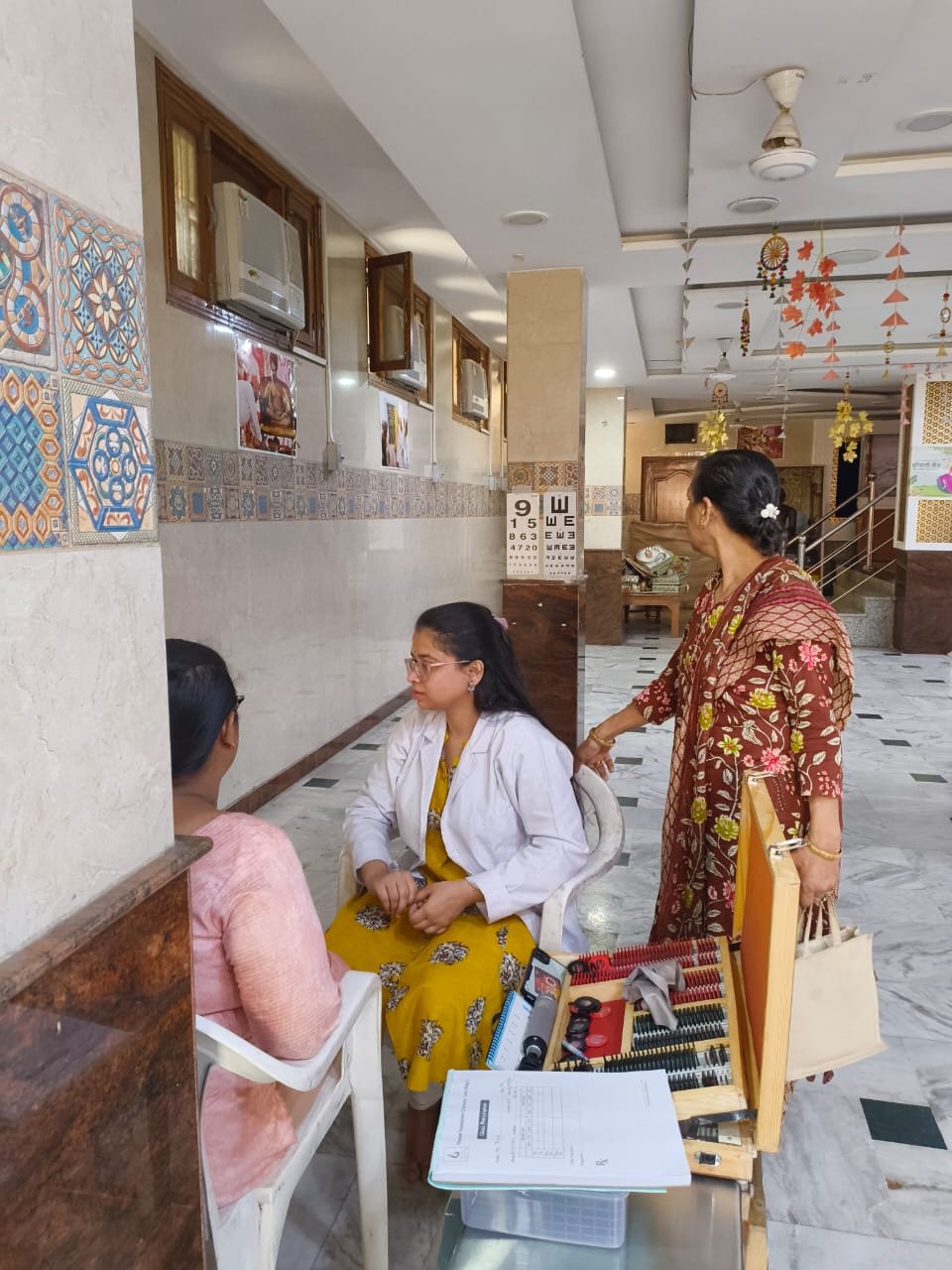 Optometrist conducting a vision test at the eye camp